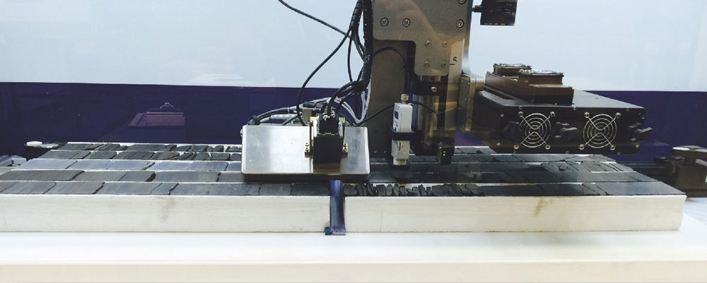 Slabbed oil and gas rock core in boxes undergoing detailed high resolution XRF, point magnetic susceptibility and UV/Visible linescan photography.